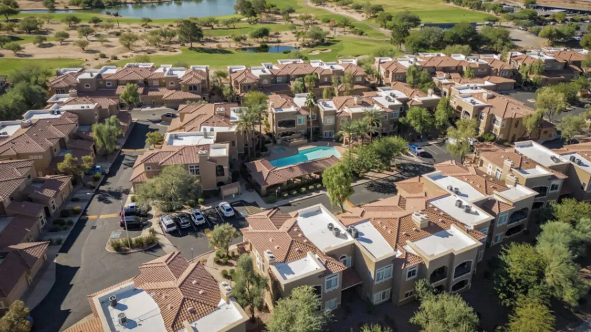 Overlooking the complex's main swimming pool, this image features residents enjoying the sunny outdoors, surrounded by landscaped gardens and modern residential buildings. The inviting patio and open spaces suggest ample room for social gatherings and relaxation.